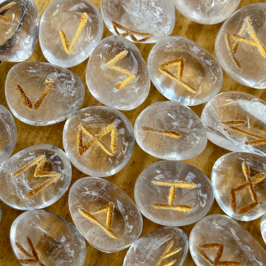 This beautiful set of Clear Quartz runes can be used to bring new energy to your divination, magic, and meditation practices  This set of runes is intricately-carved with the ancient symbols of the gods of the North, and includes a charming pouch for easy carrying. Each set has 25 Runes, 24 with characters on them and a single blank rune