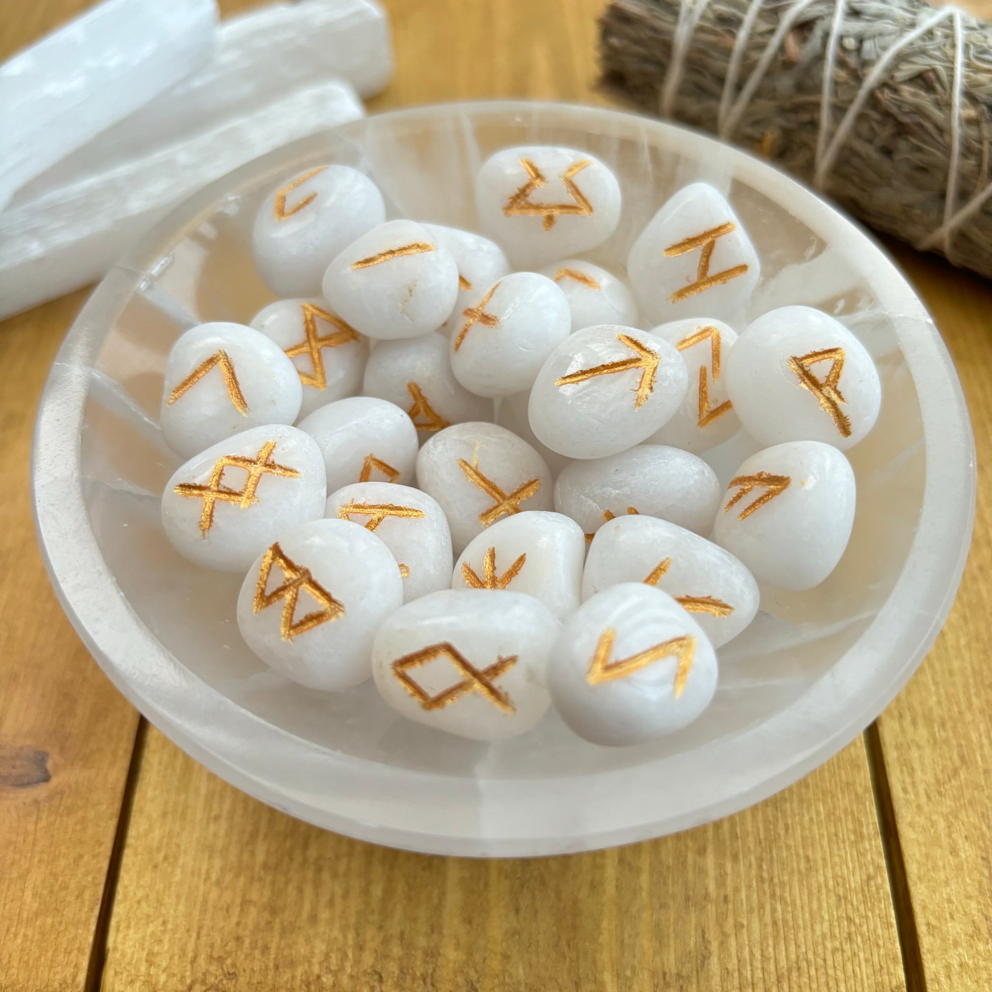This beautiful set of White Agate runes can be used to bring new energy to your divination, magic, and meditation practices  This set of runes is intricately-carved with the ancient symbols of the gods of the North, and includes a charming pouch for easy carrying. Each set has 25 Runes, 24 with characters on them and a single blank rune