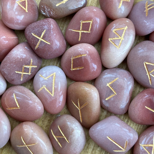 This beautiful set of Red Aventurine runes can be used to bring new energy to your divination, magic, and meditation practices  This set of runes is intricately-carved with the ancient symbols of the gods of the North, and includes a charming pouch for easy carrying. Each set has 25 Runes, 24 with characters on them and a single blank rune
