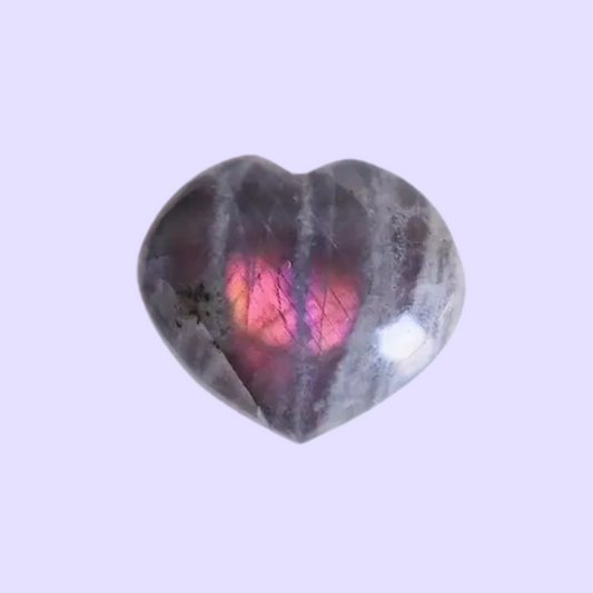 Fall in love with the one-of-a-kind Purple Labradorite Carved Heart. This unique piece features beautiful hues of purple and is hand-carved into a heart shape... it's a must-have for any crystal lover