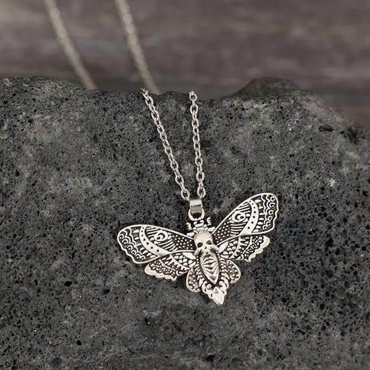 Embrace the darkness with our Death Moth Silver Necklace! This edgy, yet elegant piece features a striking death moth pendant on a sleek silver chain. Perfect for adding a touch of darkness to any outfit