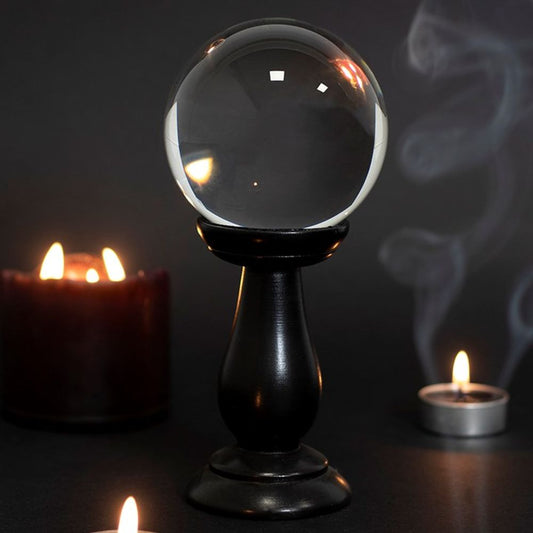 This small, clear crystal ball is not only a powerful tool in fortune telling and scrying, but also makes an eye-catching piece of décor. Whether used for divination or a table accessory at Halloween, this crystal ball is sure to be a conversation piece. Comes on black wooden stand