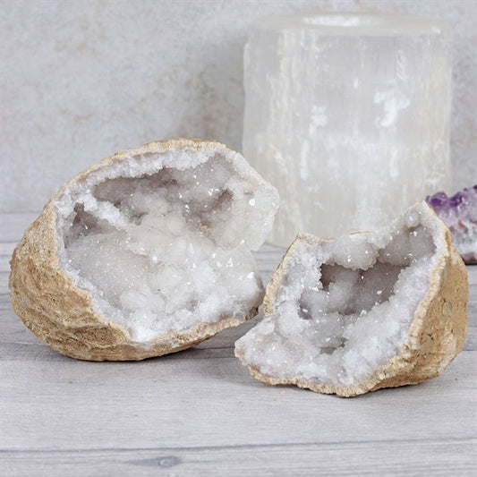 These stunning White Quartz Geodes display brilliant natural white crystal formations and showcase the perfect pairing of two unique geodes in their original form  White Quartz holds and amplifies intention, while also diffusing an aura of tranquillity, calm, and peace into one's energy field and space. A sweet stone for places of healing, White Quartz supports the clearing of energetic stagnation, and physical, emotional, and mental balance