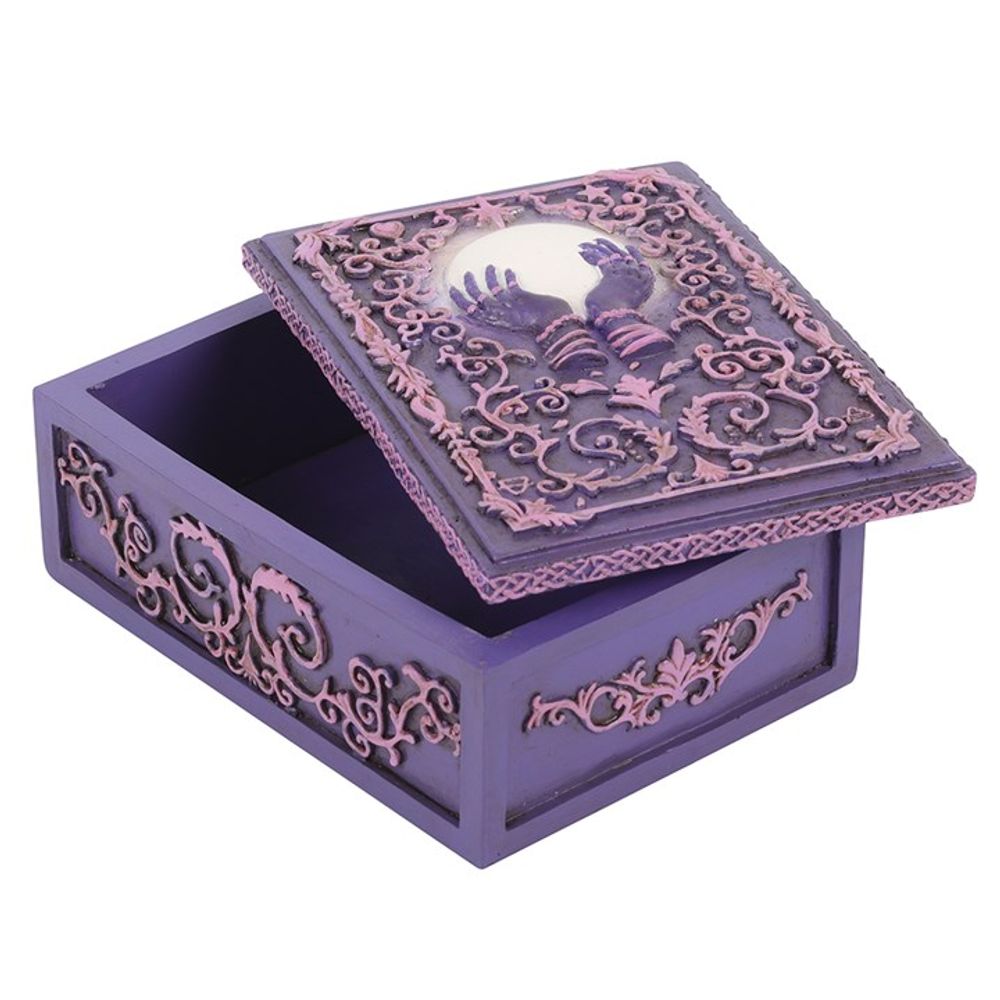 This stunning resin box features intricate filigree and a mysterious hand holding a crystal ball in the centre in pink and purple hues. Use it to store your tarot cards, crystals, herbs, and other precious objects