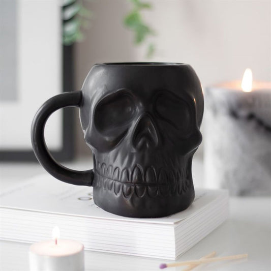 Add some edge to your morning coffee routine with this cool Black Skull Mug. This mug features a unique matt black design that is perfect for those who aren't afraid to break the mould. Whether you're sipping on coffee, tea, or something stronger, this mug is sure to make a statement