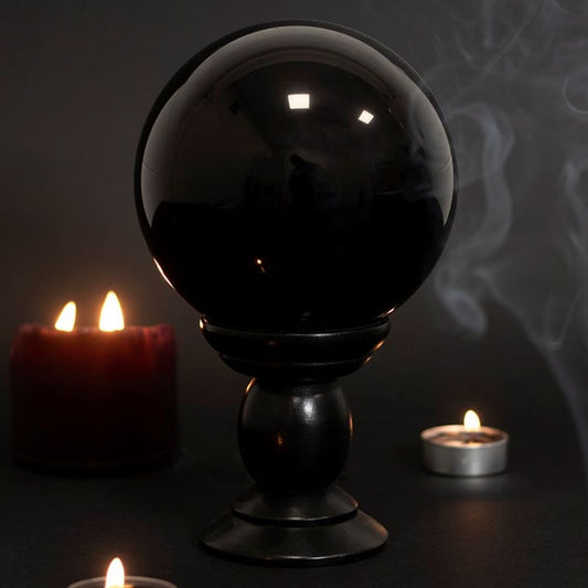 This large, black crystal ball is not only a powerful tool in fortune telling and scrying, but also makes an eye-catching piece of décor  No object is associated with the mystical ability of divination more than the Crystal Ball, having having been revered by Scryers (fortune tellers) since the middle ages  Our large, black crystal ball has a diameter of about 13 cm and comes with a black wooden stand